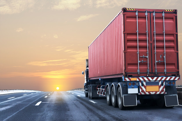truck-on-highway-road-with-red-container_42493-12